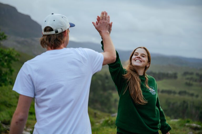 Happy high five Scotland roadtrip SUV Isle of Skye