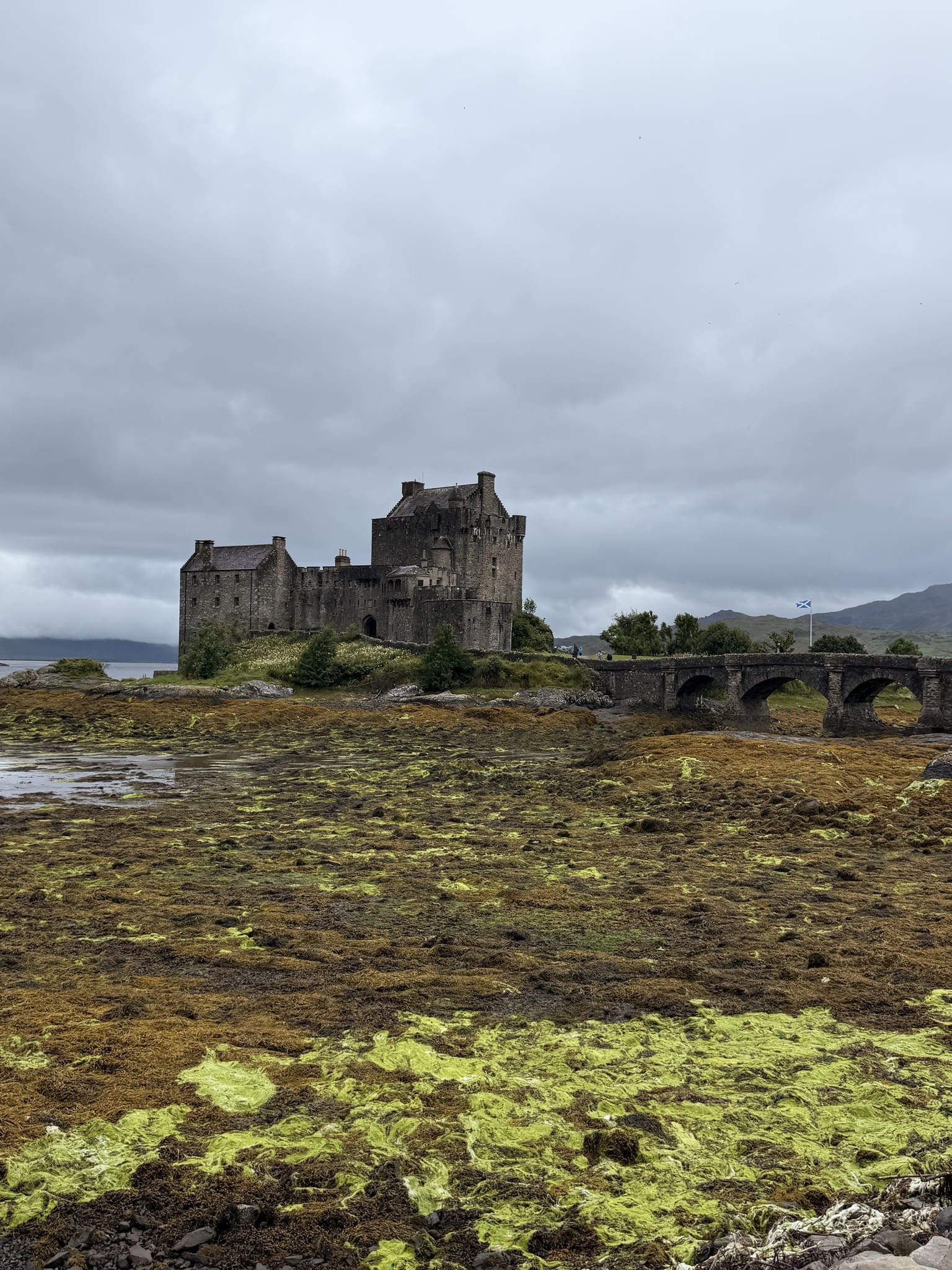 Eilean Donan Castle and bridge on a cloudy day in Scotland