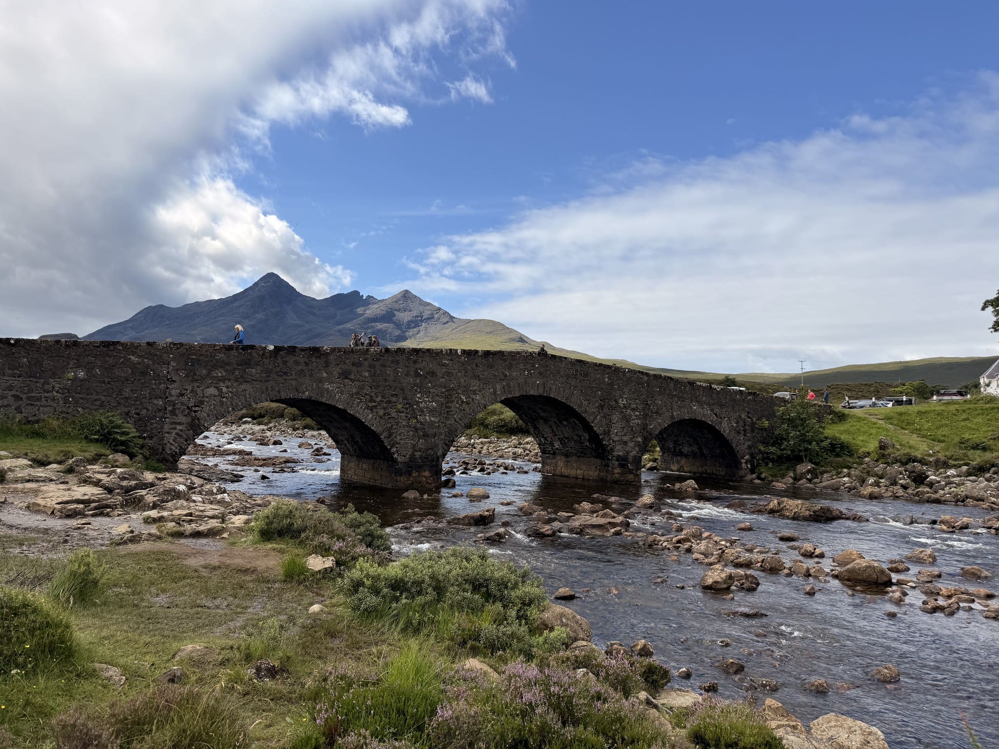 fairy pools bridge with mountains in the background